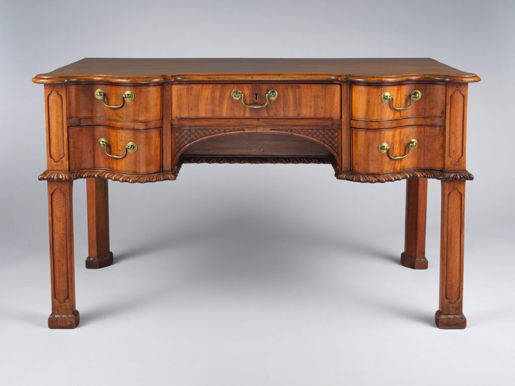 dfddds - Grand Boudoir Across eighteenth- and nineteenth‑century Europe, the simple act of adding a drawer transformed the table from a bare horizontal surface into a discreet container of private life. Writing tables housed correspondence and sealing wax, dressing tables concealed cosmetics and intimate accessories, while slender side and console tables near doors held keys, calling cards, and coins. These modest compartments altered daily routines, reorganised interiors, and encouraged new rituals of order, privacy, and display. From Georgian restrained elegance to the rich veneers of Empire and the curving exuberance of Victorian design, tables with drawers became barometers of taste and social aspiration. Cabinetmakers in London, Paris, Vienna, and beyond worked in mahogany, walnut, oak, and rosewood, refining drawer construction with hand‑cut dovetails, oak or deal linings, and runners worn smooth by centuries of use. Their craftsmanship is still legible in the quiet details: the weight of a solid oak drawer bottom, the faint irregularity of a hand‑filed brass handle, or the subtle ripples of planed timber beneath an old polish. For today’s collector, understanding these nuances is essential. The distinction between a writing table and a side table, between an original dressing table and one later “improved” with extra drawers, rests on reading proportions, construction methods, and wear patterns as closely as any archival document. Equally, restoration—too often heavy‑handed—can blur the very evidence that proves authenticity, from replaced drawer runners to over‑polished tops that erase the soft sheen of age. As demand grows for honest, usable antique furniture, genuine tables with intact drawers, sympathetic repairs, and untouched interiors are increasingly prized, not merely as decorative accents, but as historical witnesses to the evolving choreography of work, leisure, and privacy in the European home.