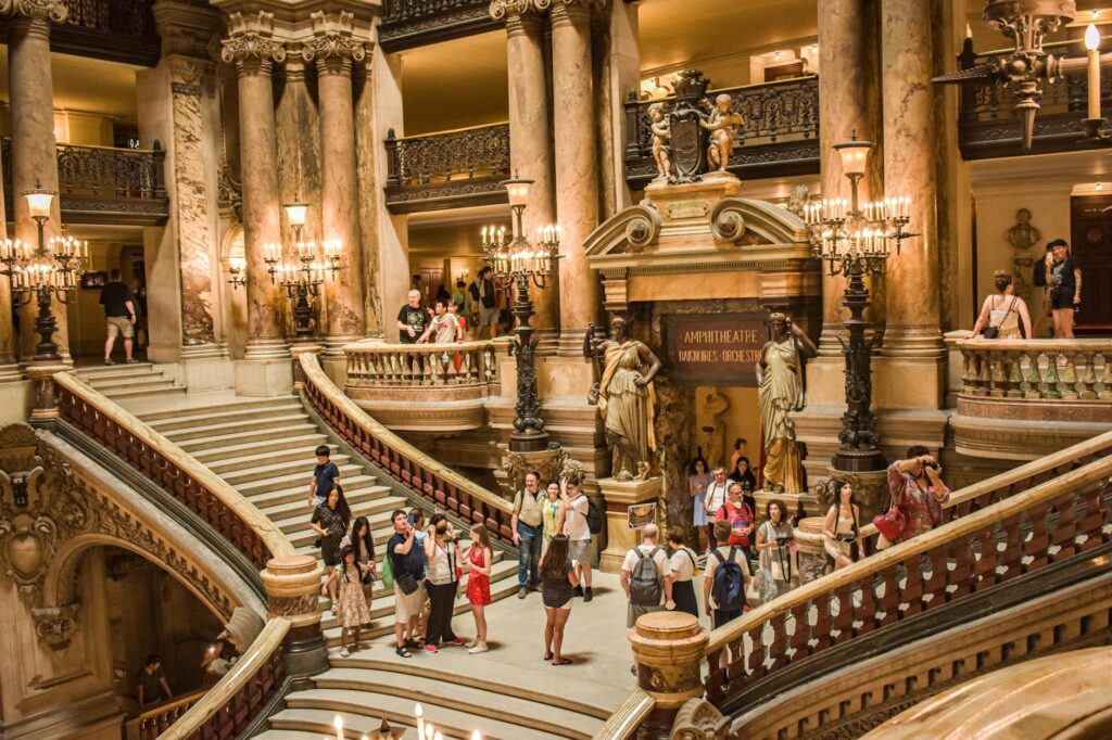 French Aristocracy 5 - Grand Boudoir Tourists admire the grand staircase inside Palais Garnier, a famous landmark in Paris, France.