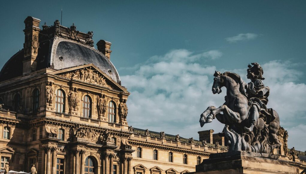 Whispers of Power and Velvet: Inside the Symbolic Interiors of the French Aristocracy Elegant view of the Louvre Museum and equestrian statue under a clear sky in Paris, France.