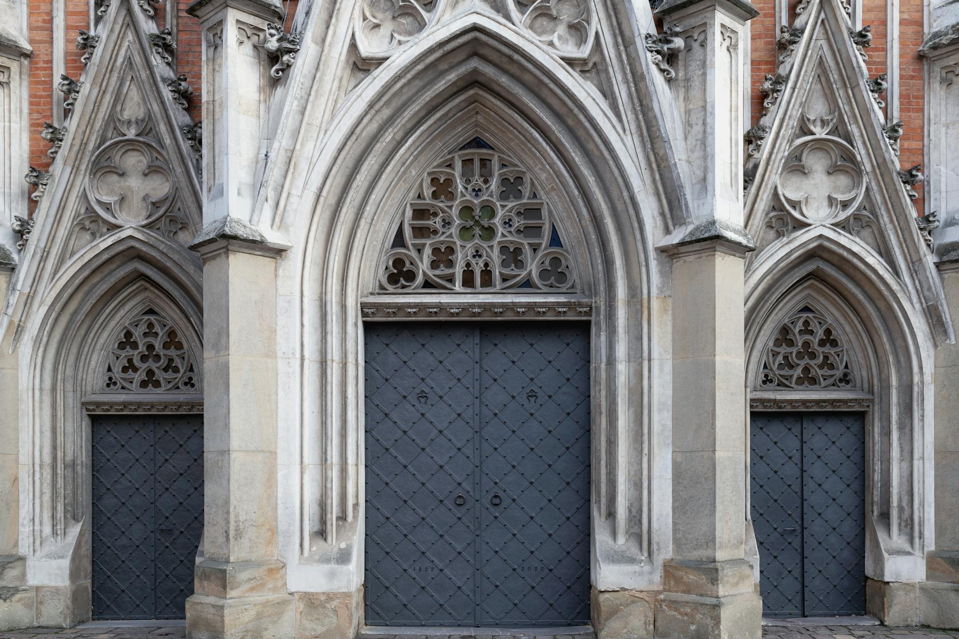 The Hidden Psychology of Gothic Cathedrals 1 - Grand Boudoir Detailed view of a Gothic cathedral entrance with ornate arches and stone carvings.
