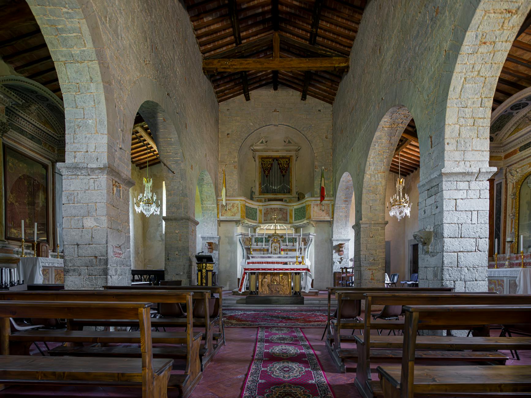 The Hidden Psychology of Gothic Cathedrals 2 - Grand Boudoir Elegant interior of a historic church featuring stone arches and wooden pews.
