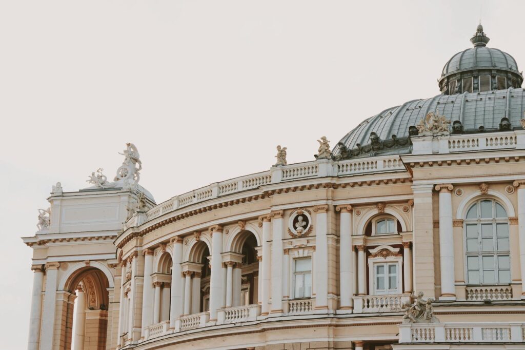 Elegant architecture featuring a dome and arches, with intricate sculptures and statues.