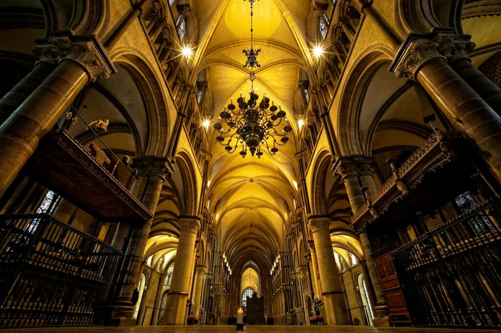 pexels photo 30034665 - Grand Boudoir The stunning Gothic architecture of Canterbury Cathedral's interior with arched ceilings and chandeliers.