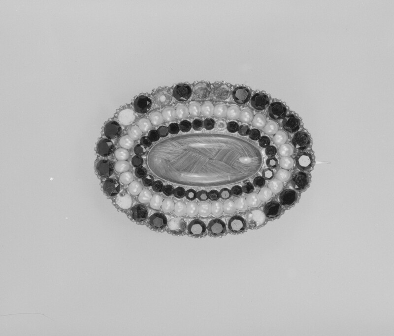 1713991 - Grand Boudoir Discover the secrets behind Victorian mourning brooches—tiny relics of grief, love, and hidden messages worn close to the heart.