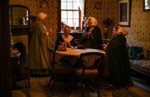 Victorian Upholstery Fabric: History, Craft, and Lasting Appeal Victorian women in a cozy parlor engaged in conversation, dressed in period attire.