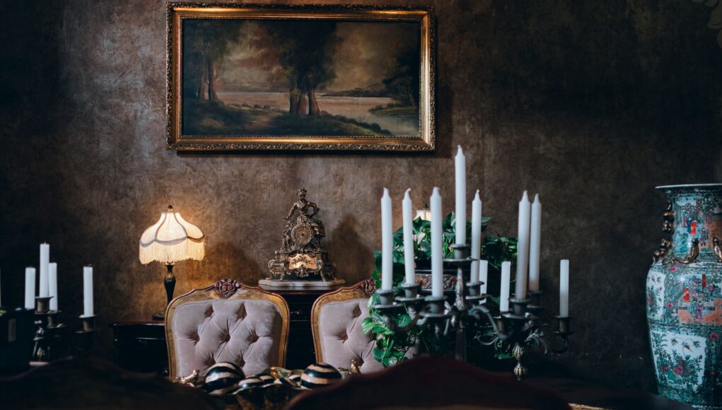 Sophisticated vintage dining room featuring elegant decor, candleholders, and classic artwork. Perfect for a luxurious setting. Sophisticated vintage dining room featuring elegant decor, candleholders, and classic artwork. Perfect for a luxurious setting.