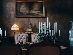 Empire style interior design embracing Napoleonic grandeur Sophisticated vintage dining room featuring elegant decor, candleholders, and classic artwork. Perfect for a luxurious setting.