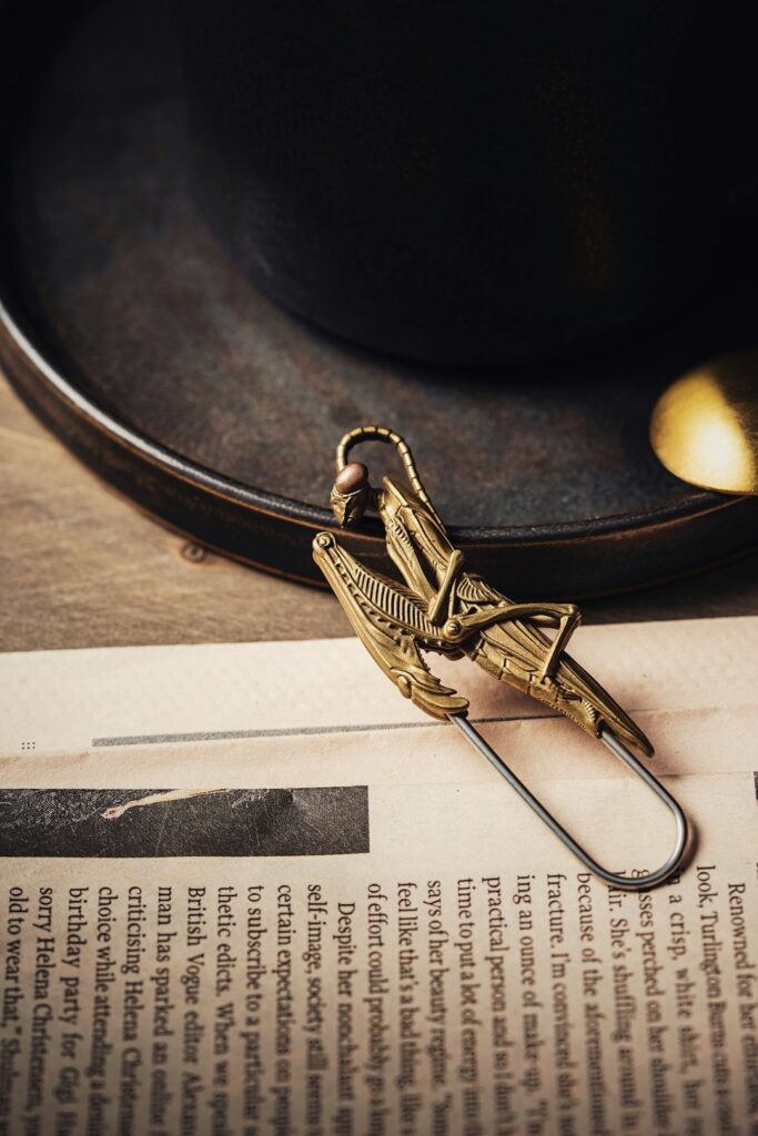 a hat and a paper clip on a table